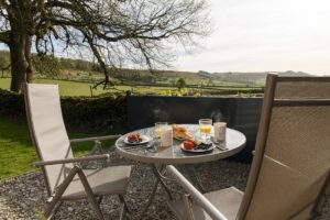 Enjoying breakfast outside the Merlin Shepherds Hut