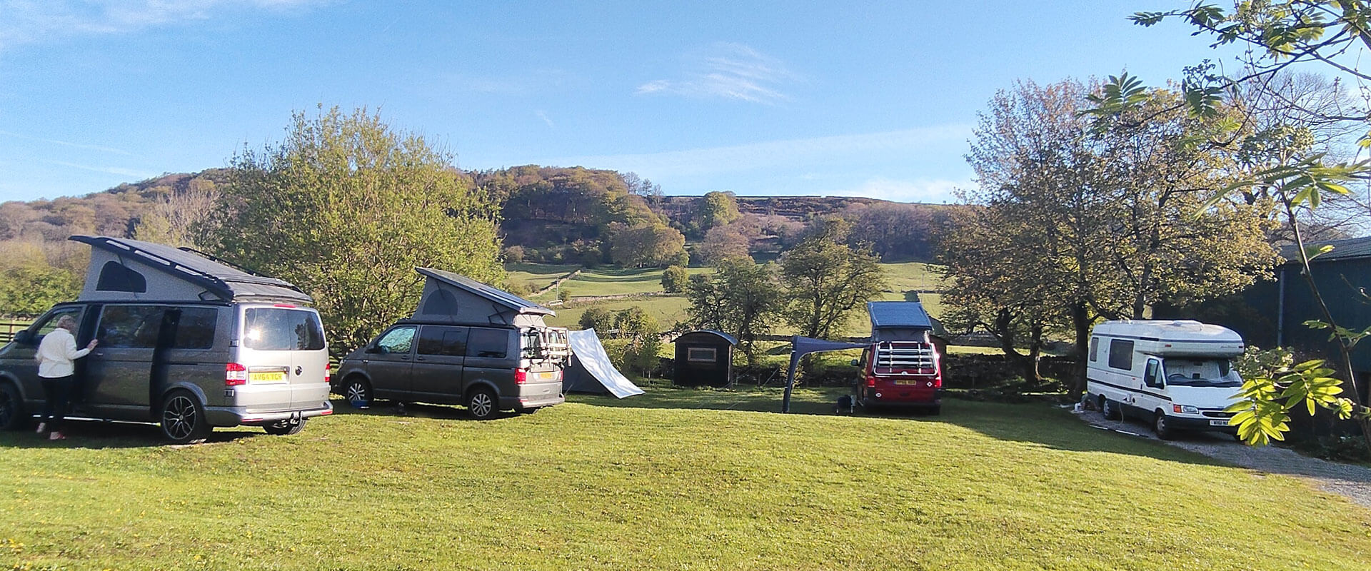 Derbyshire Hills campsite, with camper vans, tent and shepherds hut