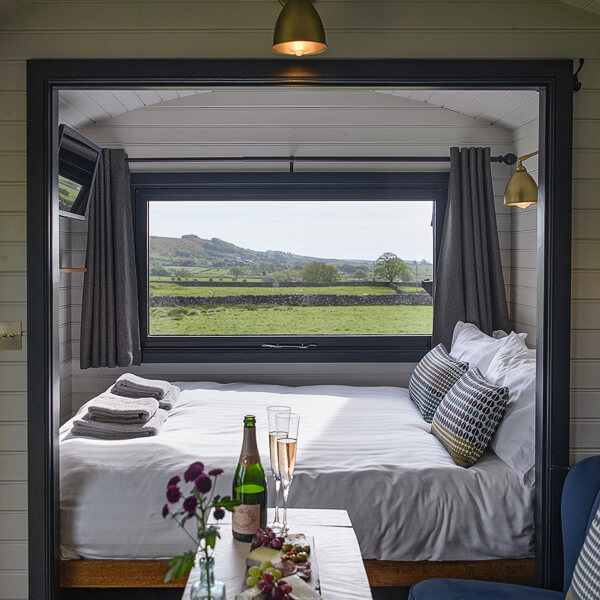 Merlin Shepherds Hut bedroom with views over the Peak District
