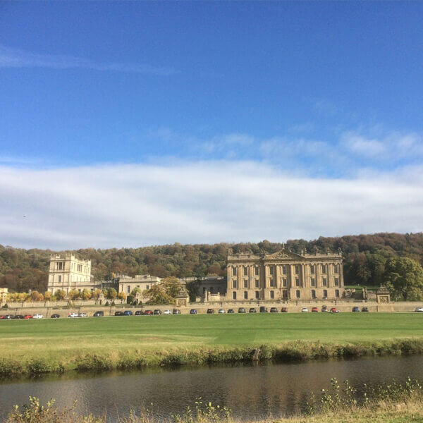 chatsworth-house-acrross-the-derwent-valley Chatsworth house seen from across the derwent valley in autumn, with stand wood rising behind