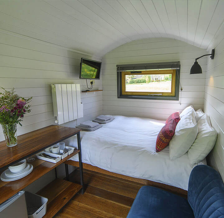 Living Space and bed in the Lapwing Shepherds Hut in Derbyshire